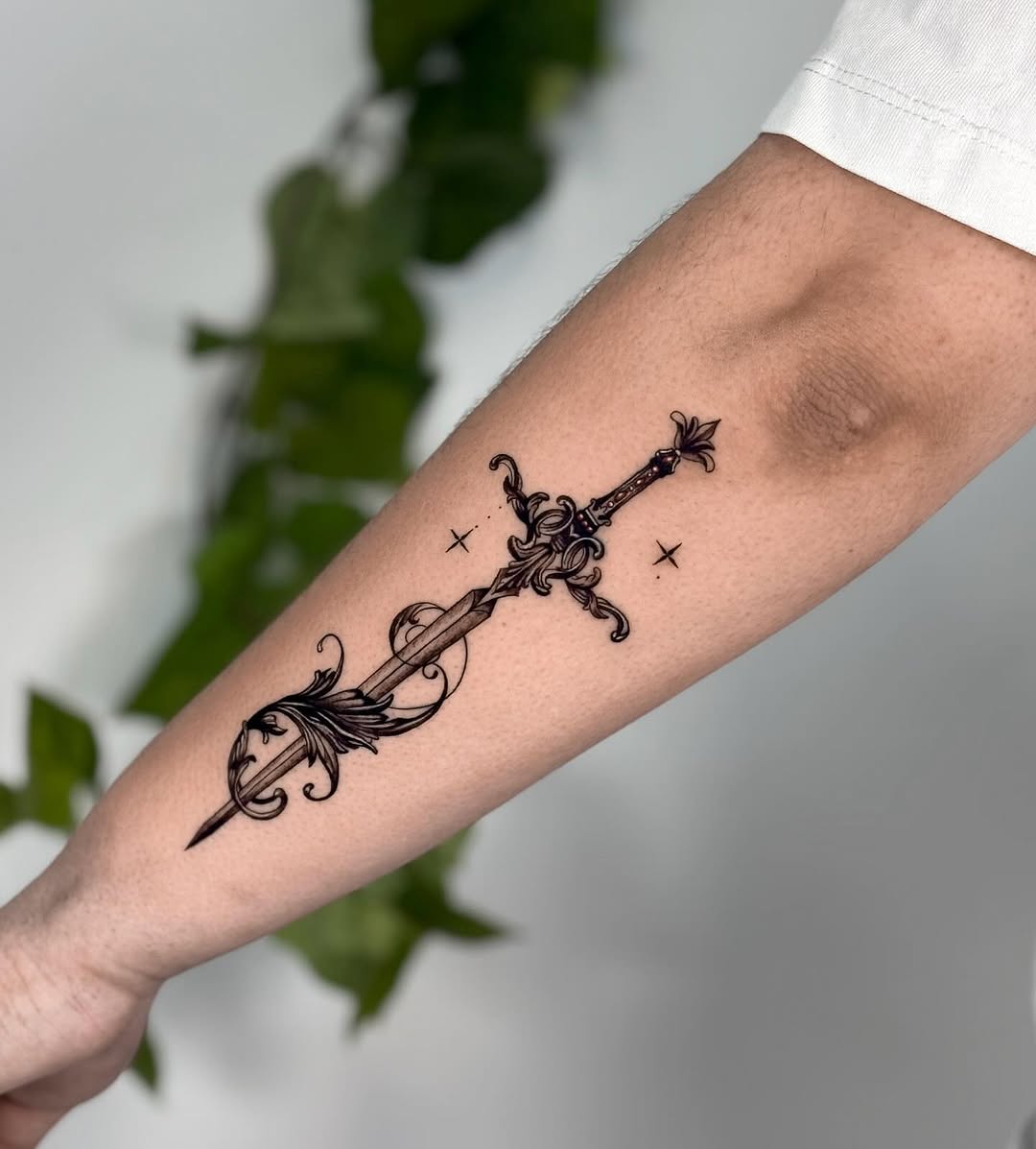 Elegant sword tattoo with detailed design