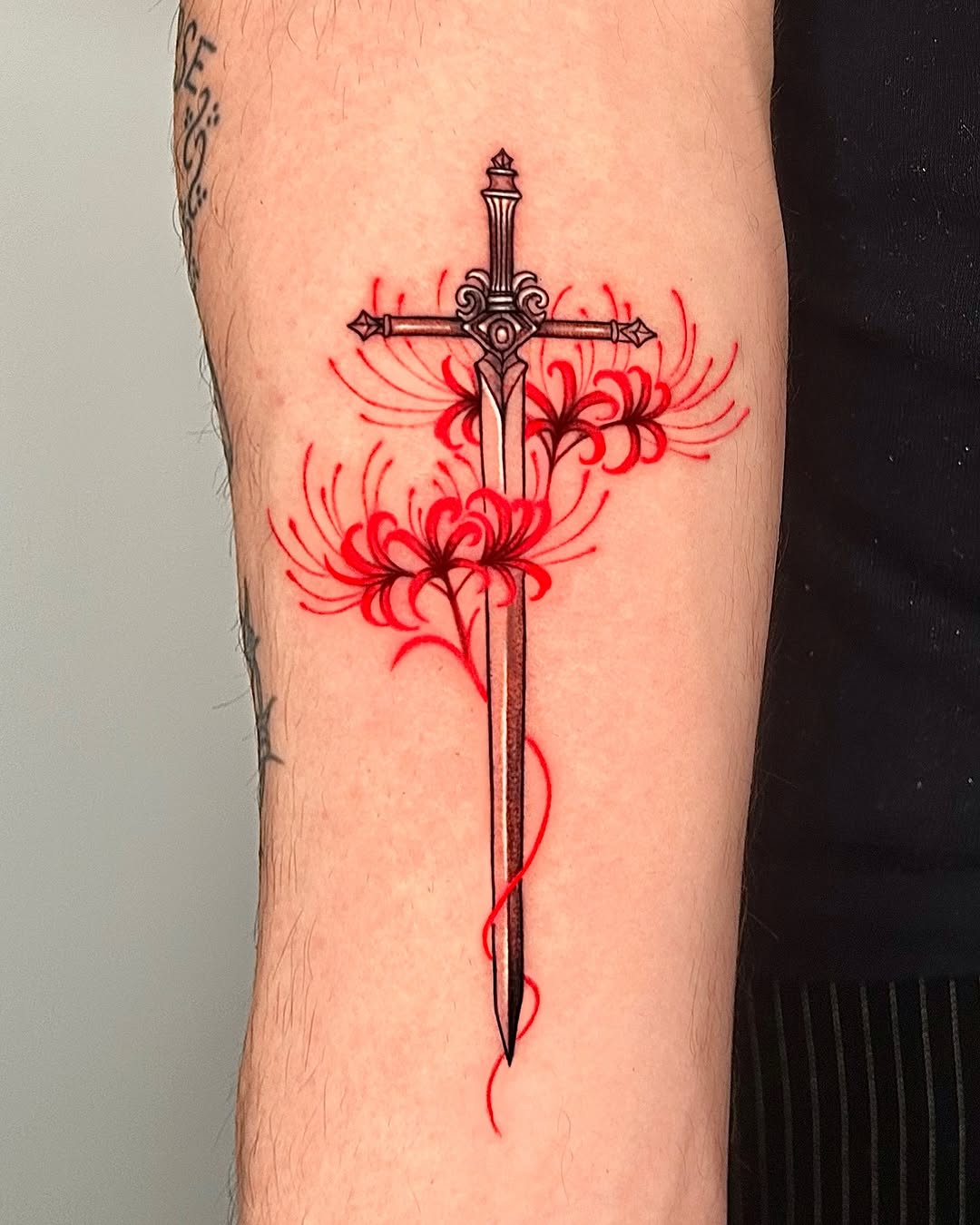 Elegant sword tattoo with floral accents