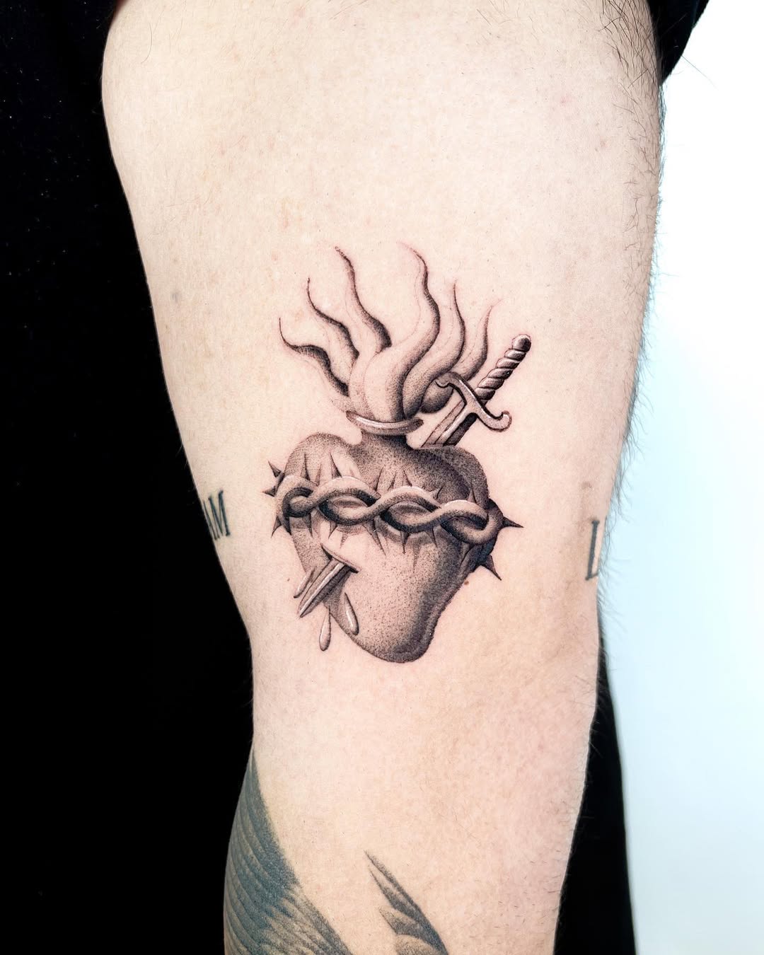Artistic sword tattoo entwined with a heart