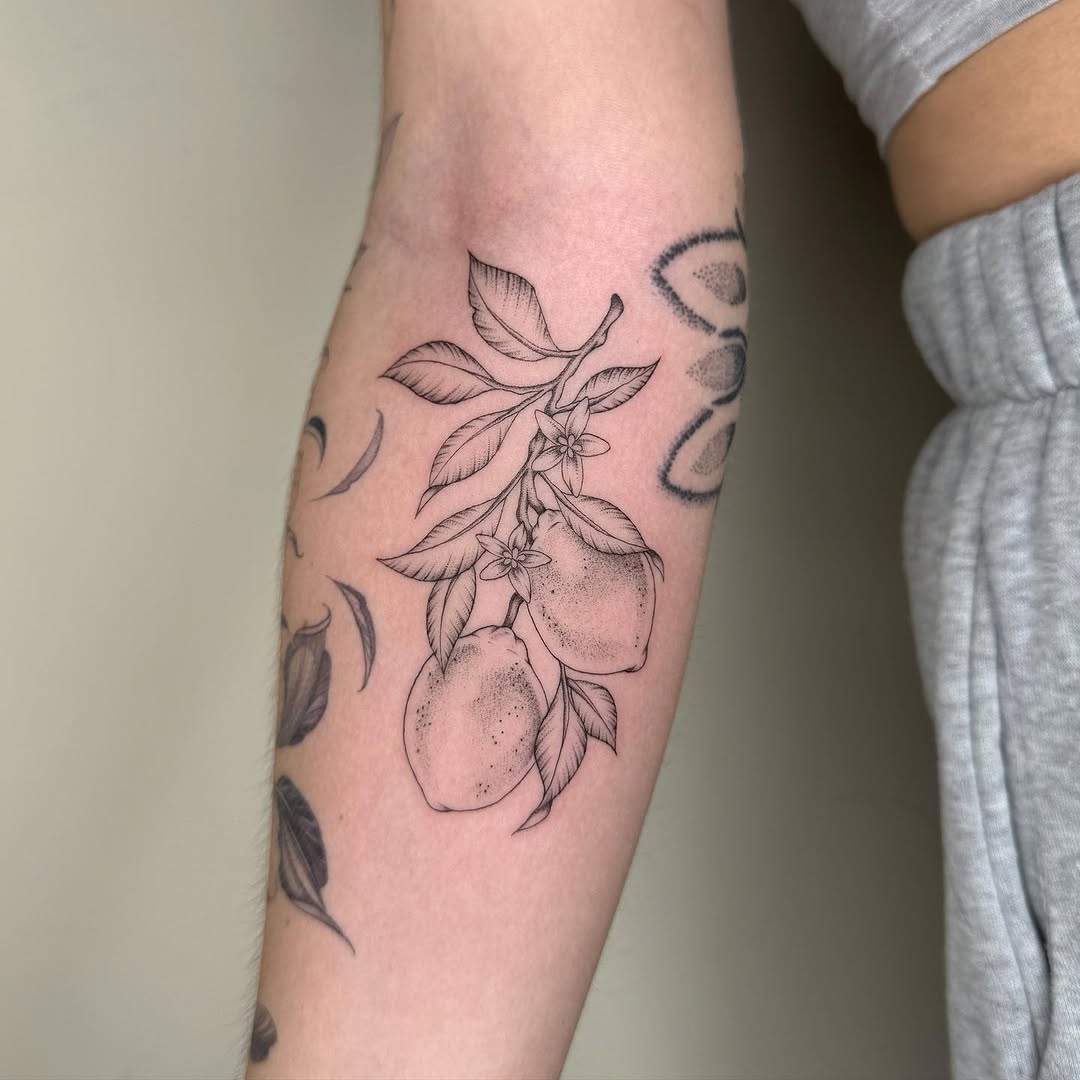 Elegant lemon tattoo with delicate floral details