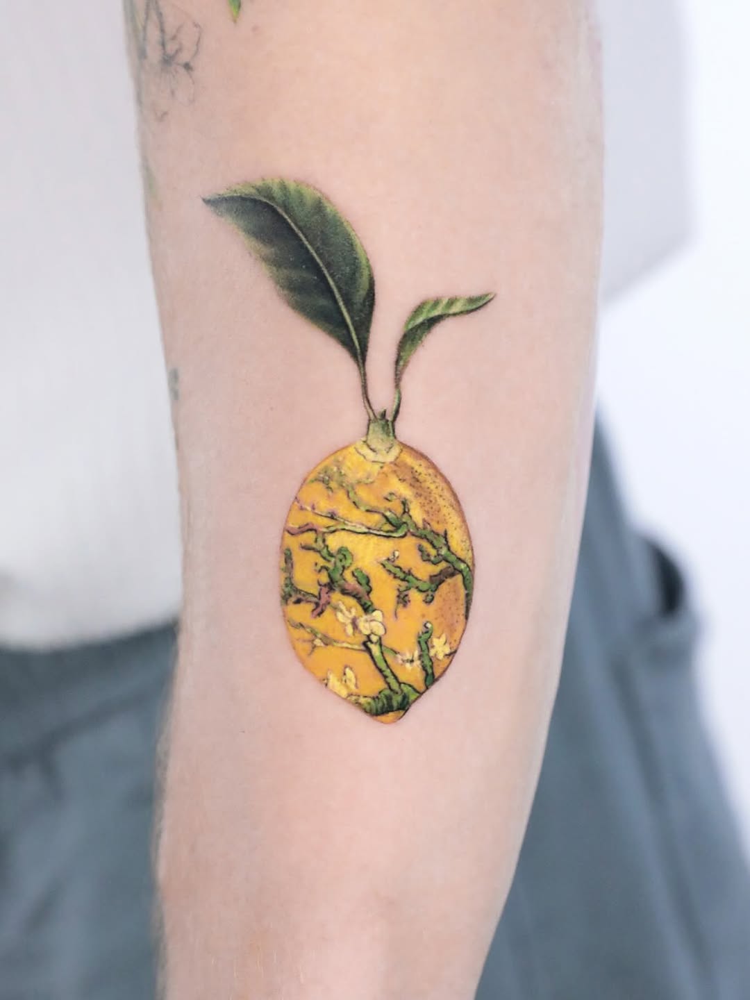 Whimsical Lemon Tattoo with Leaf Design