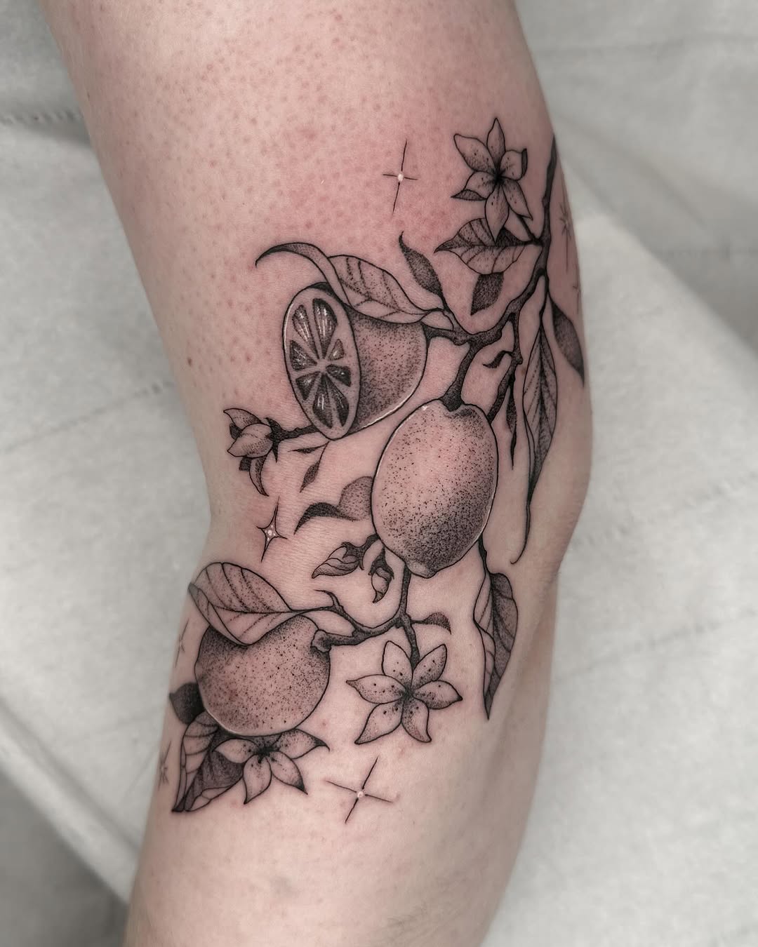 Beautiful lemon tattoo with floral elements