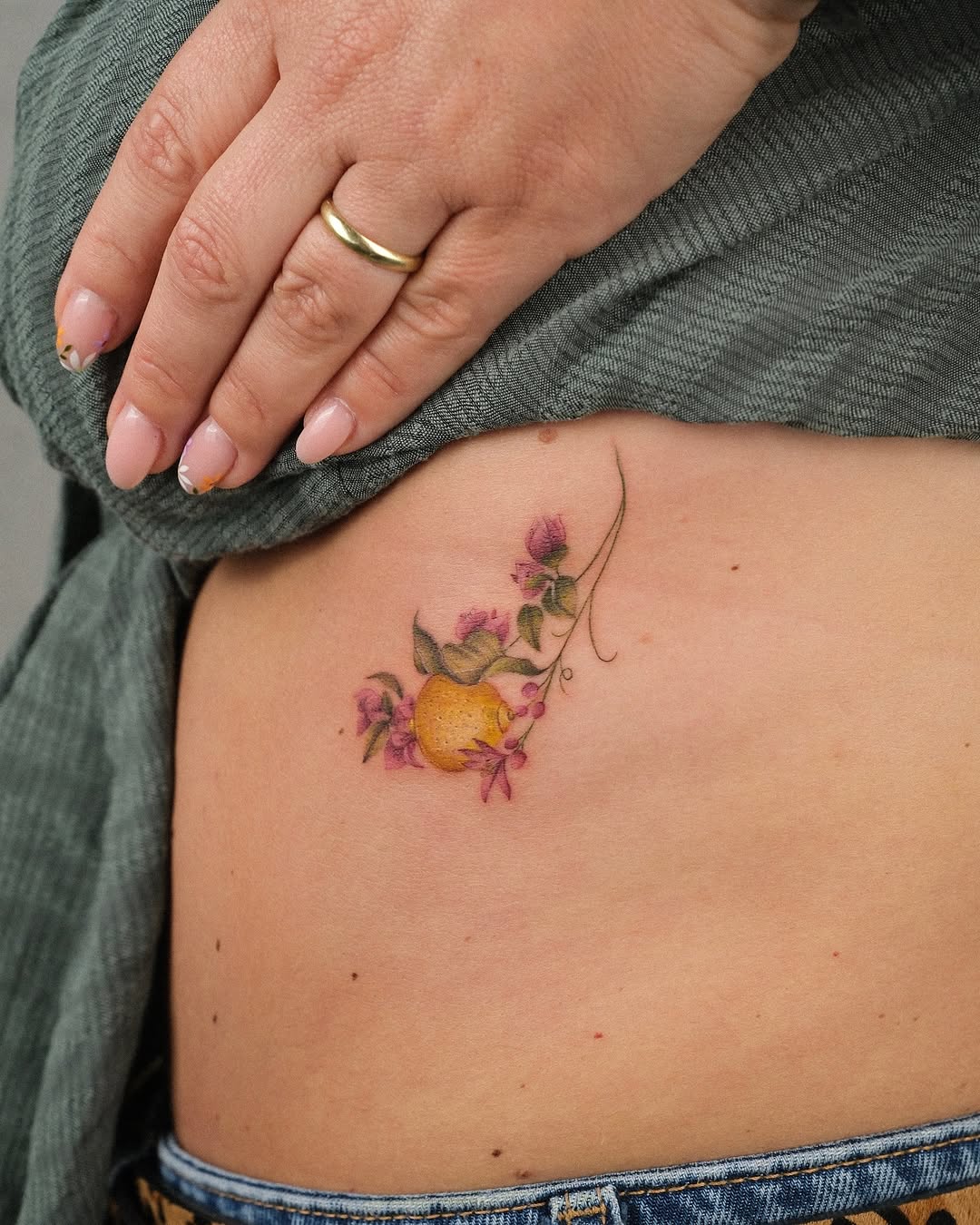 Charming lemon tattoo with floral elements
