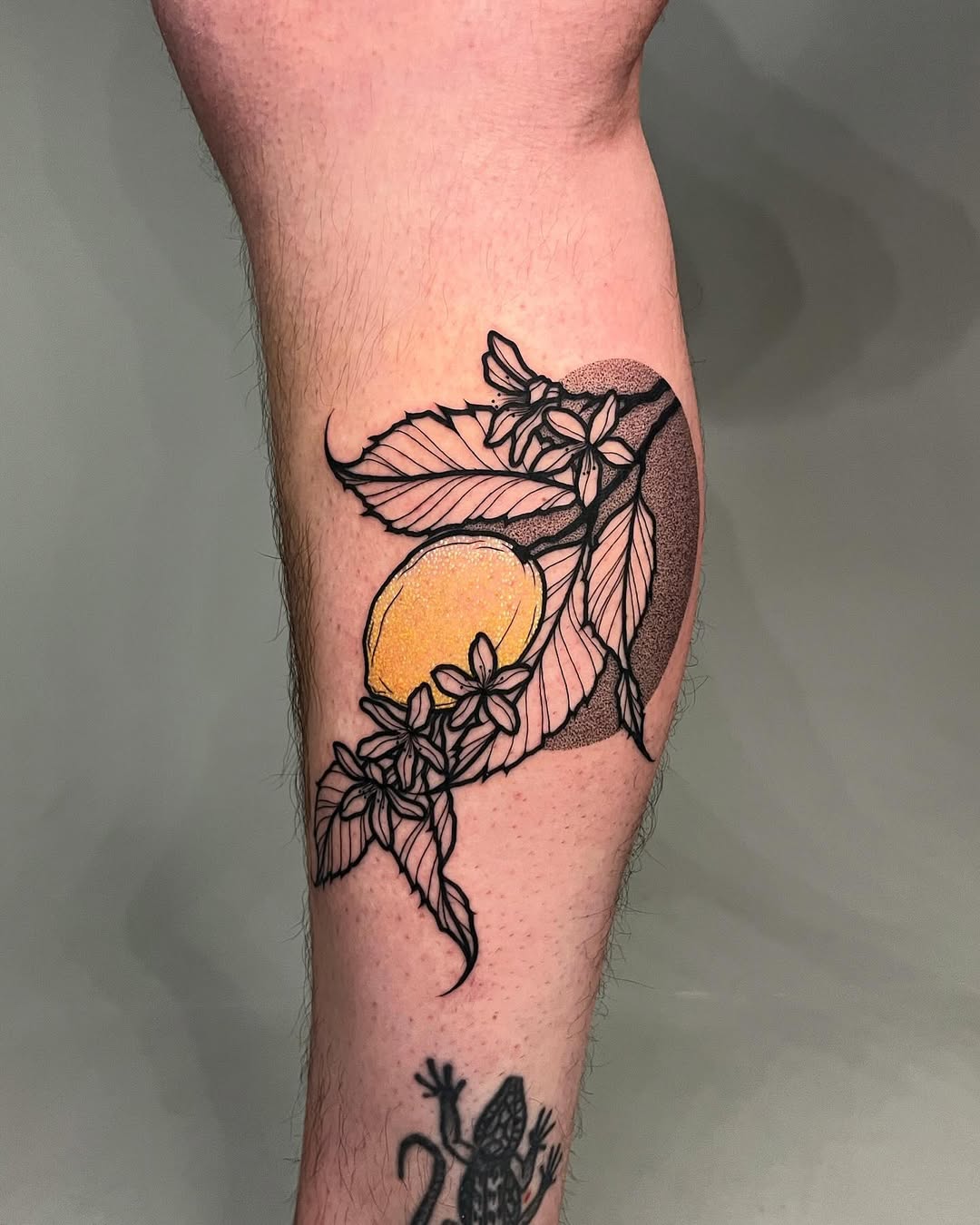 Elegant lemon tattoo with floral accents