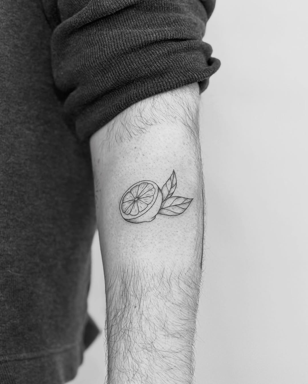 Charming black and white lemon tattoo design