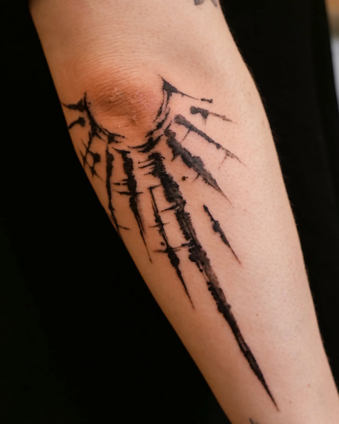 Dynamic Sun Rays Tattoo Design on Forearm