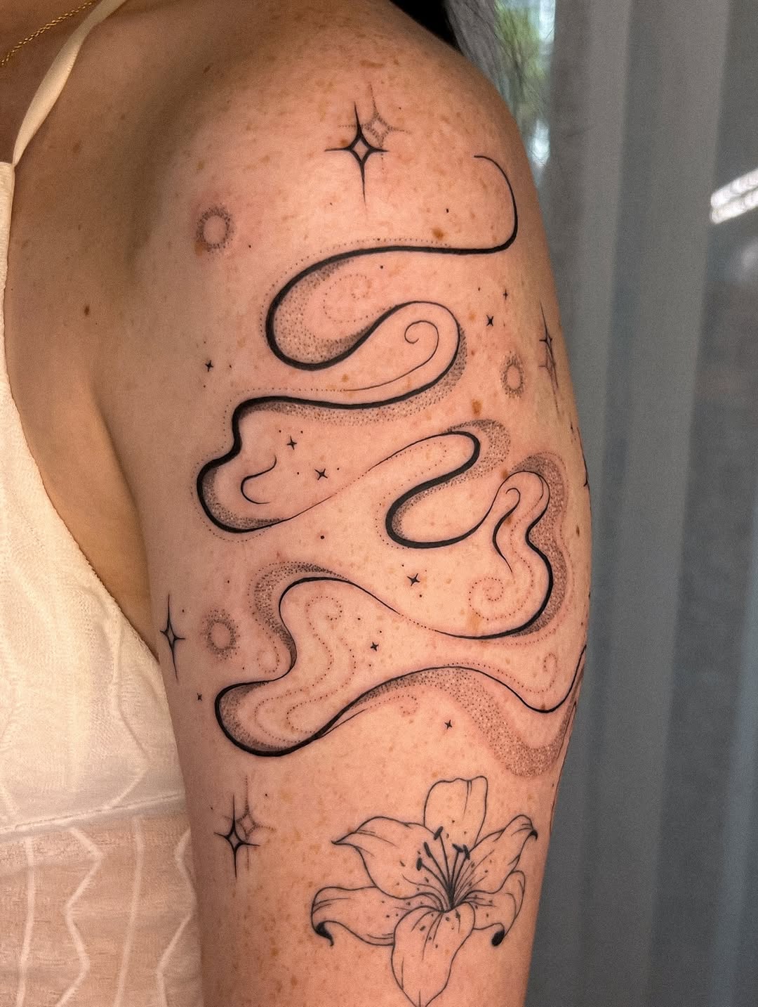 Whimsical curves and celestial accents on skin