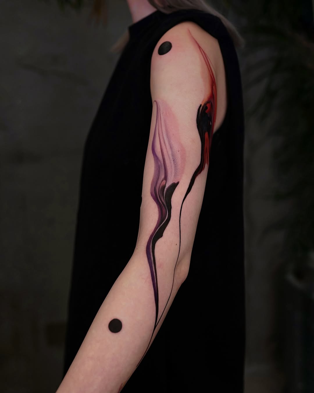 Fluid abstract tattoo flowing with vibrant colors
