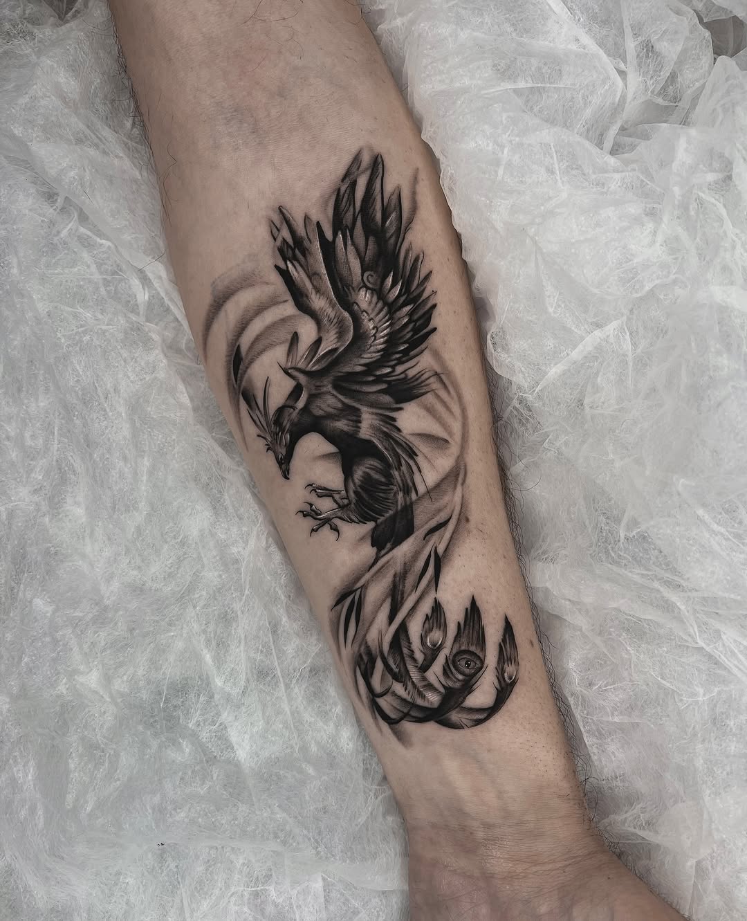 Dynamic bird tattoo symbolizing rebirth and freedom