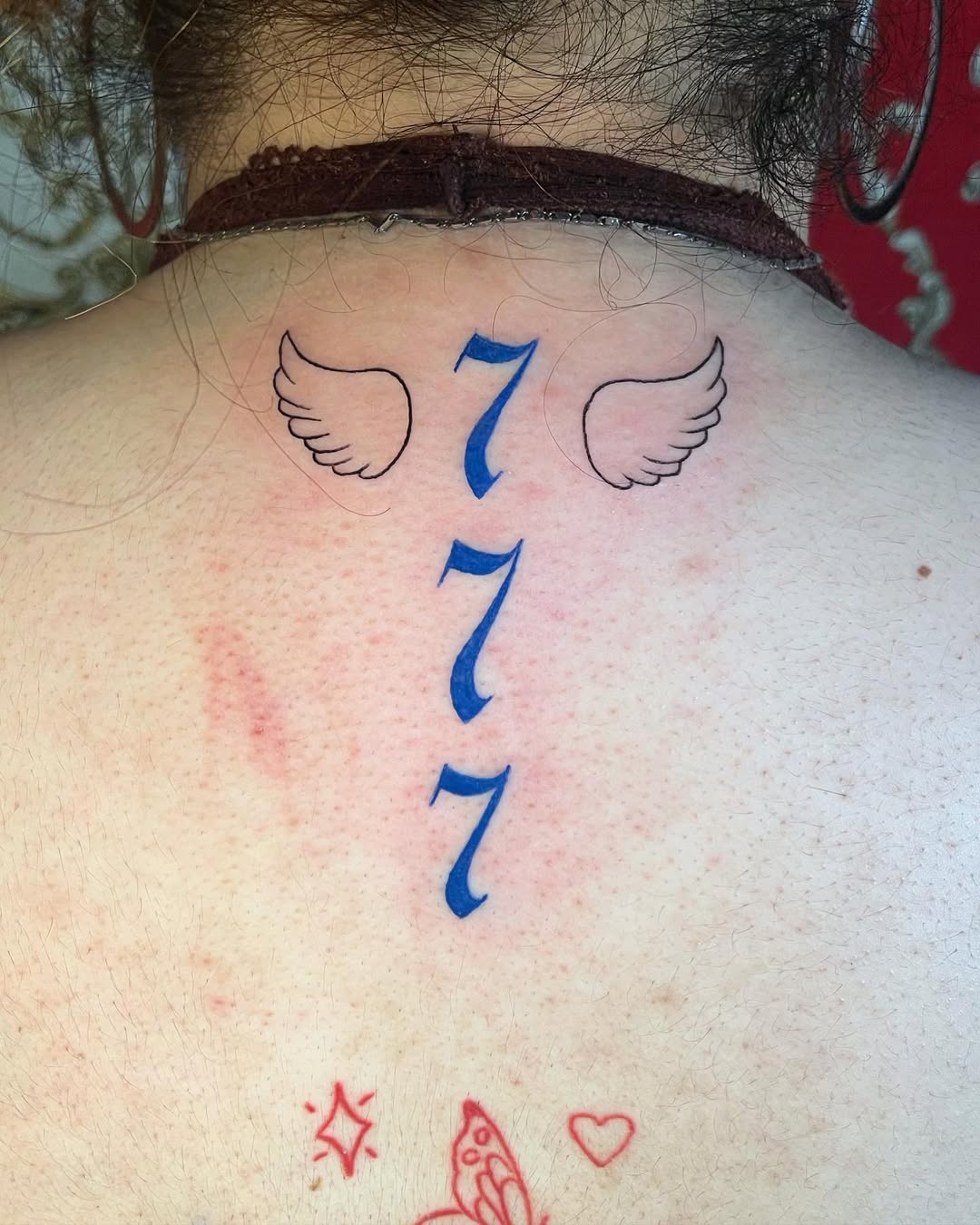 Unique winged 777 tattoo design on back