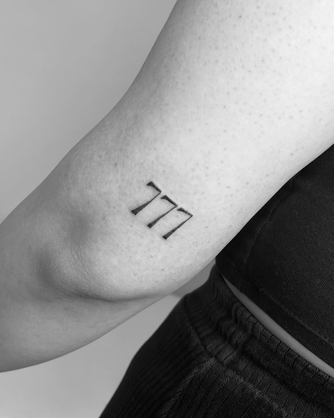 Minimalist 777 Tattoo on Arm