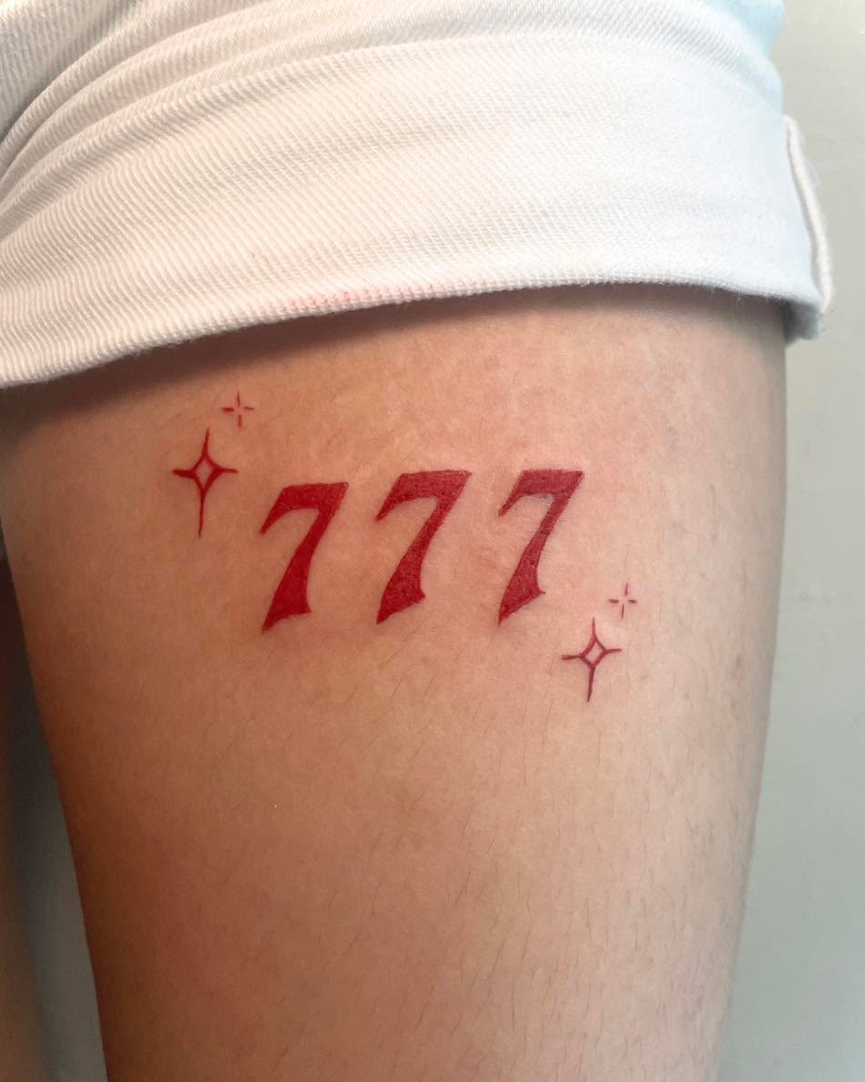 Vivid Red 777 Tattoo with Sparkling Stars