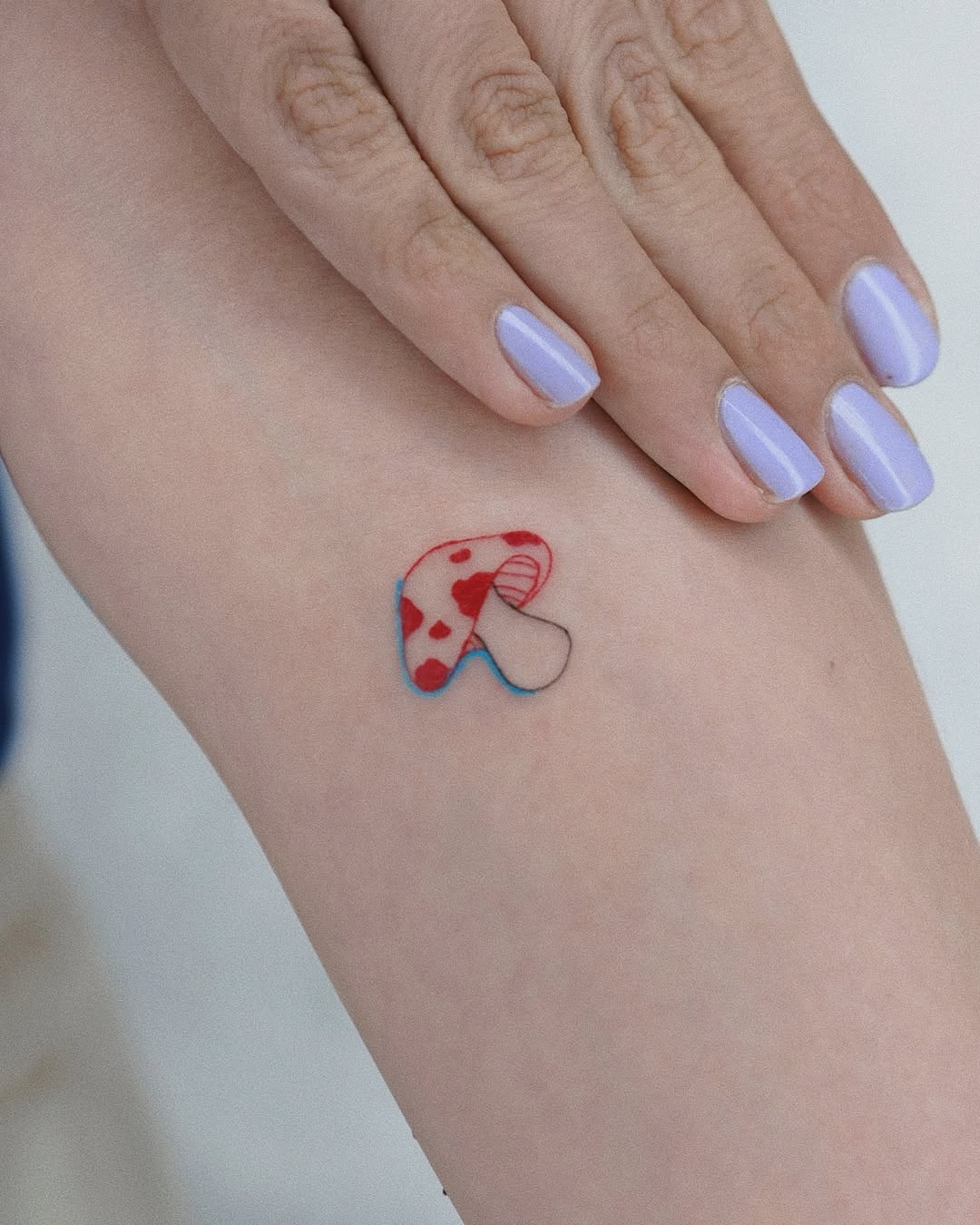 Colorful mushroom tattoo with a playful design