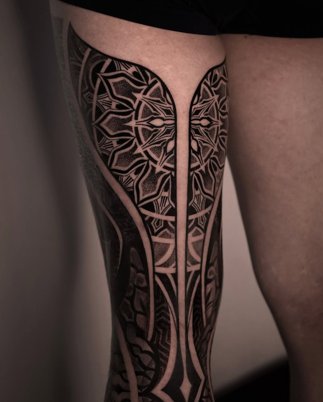 Intricate mandala tattoo design on the leg