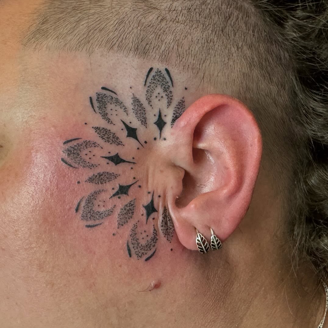 Intricate black mandala design on the head