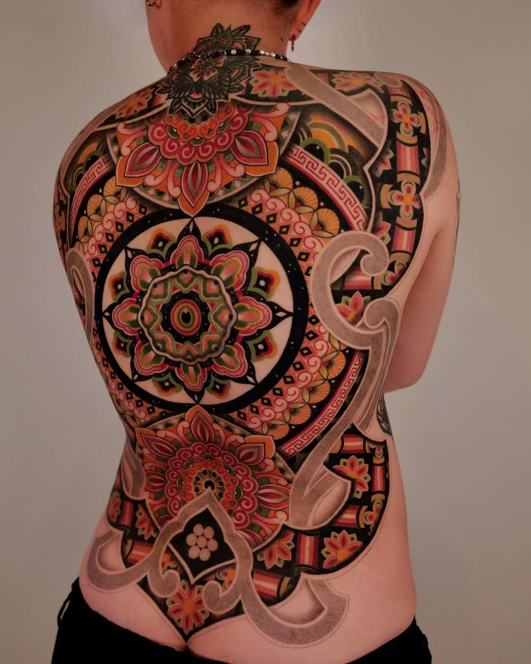 Intricate back mandala tattoo design in vibrant colors