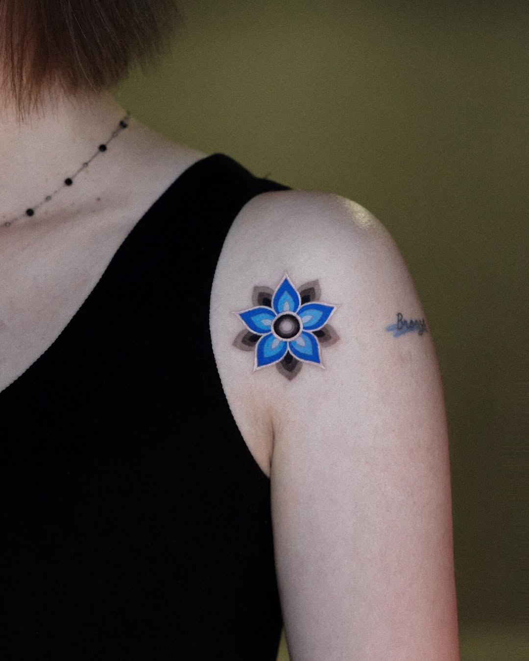 Stylish blue mandala flower tattoo on shoulder