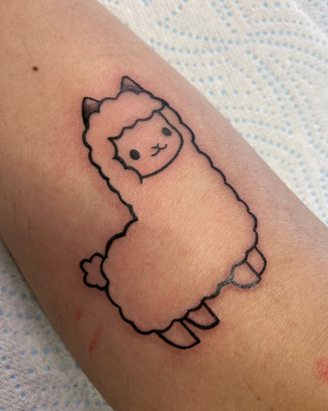 Adorable cartoon llama tattoo for playful vibes