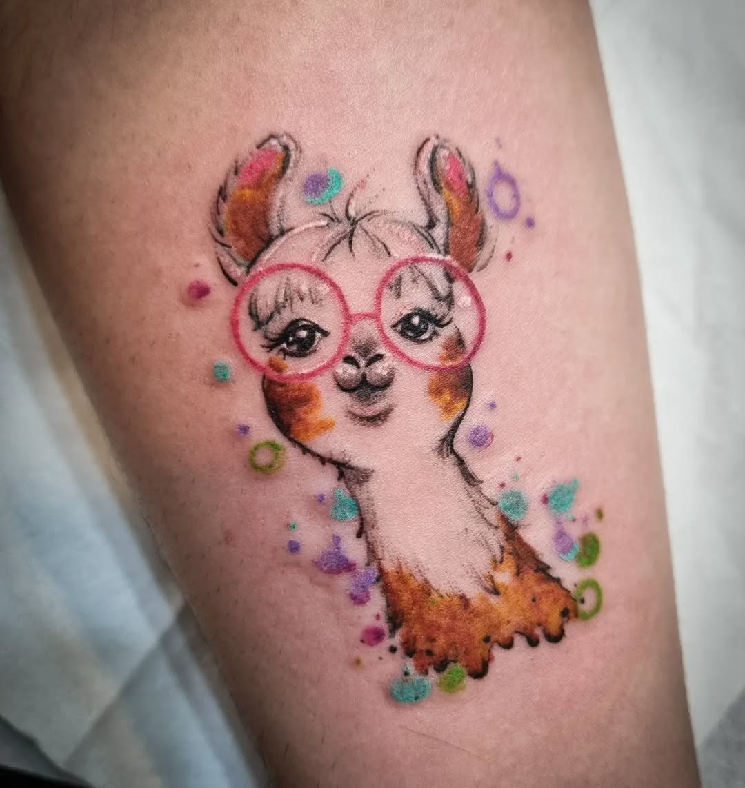 Charming llama tattoo with playful glasses