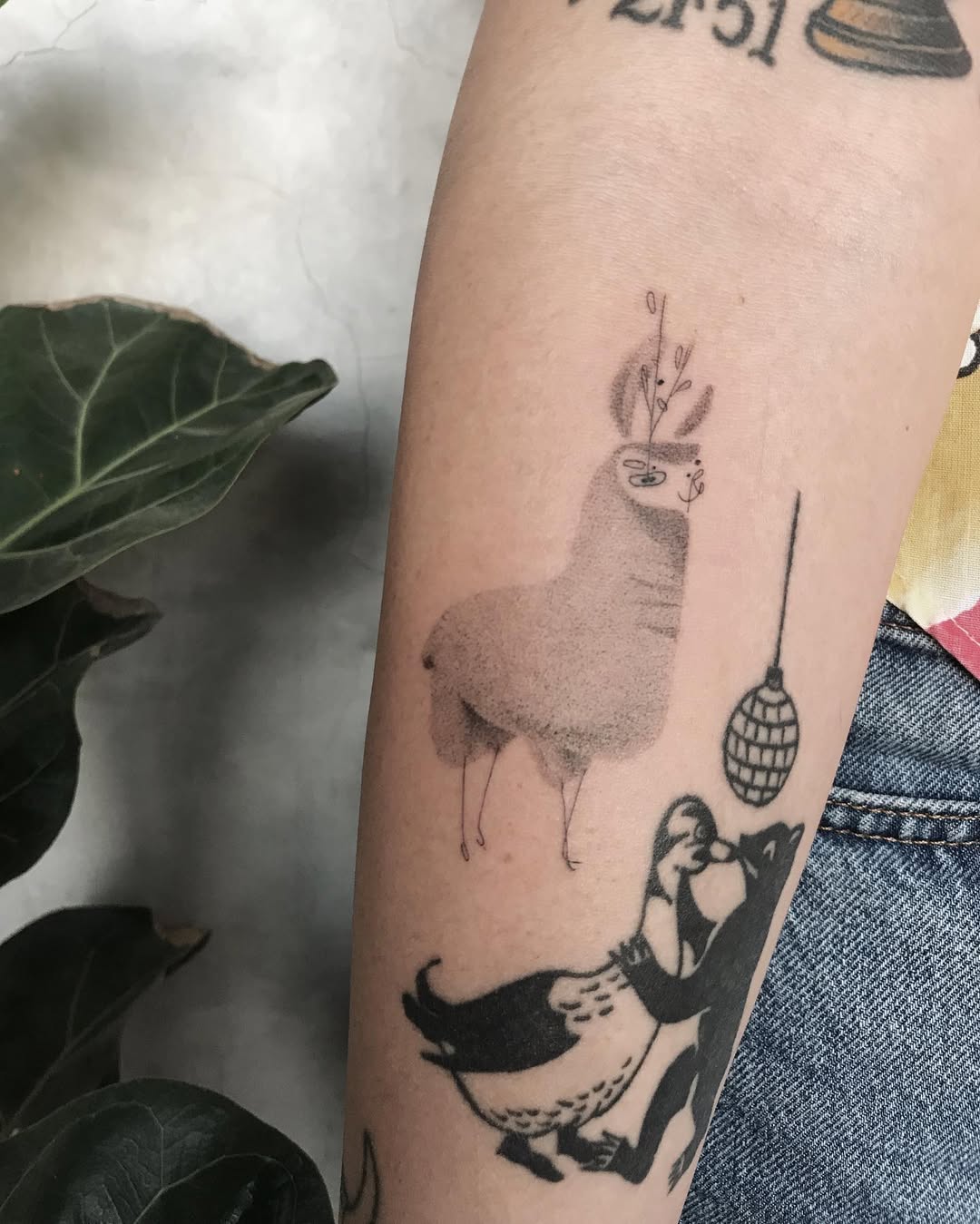 Quirky llama tattoo with whimsical details
