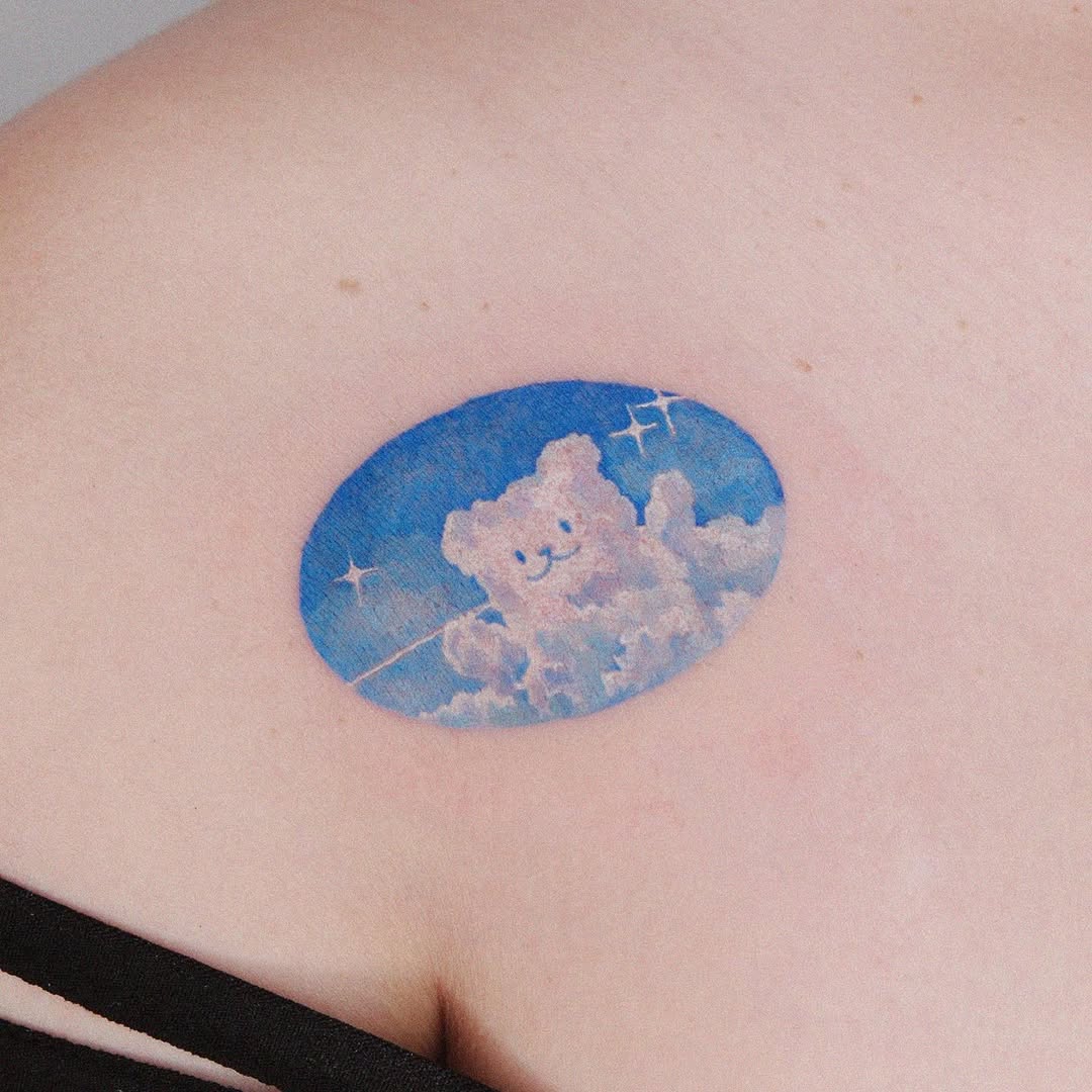 Whimsical bear tattoo in a dreamy sky