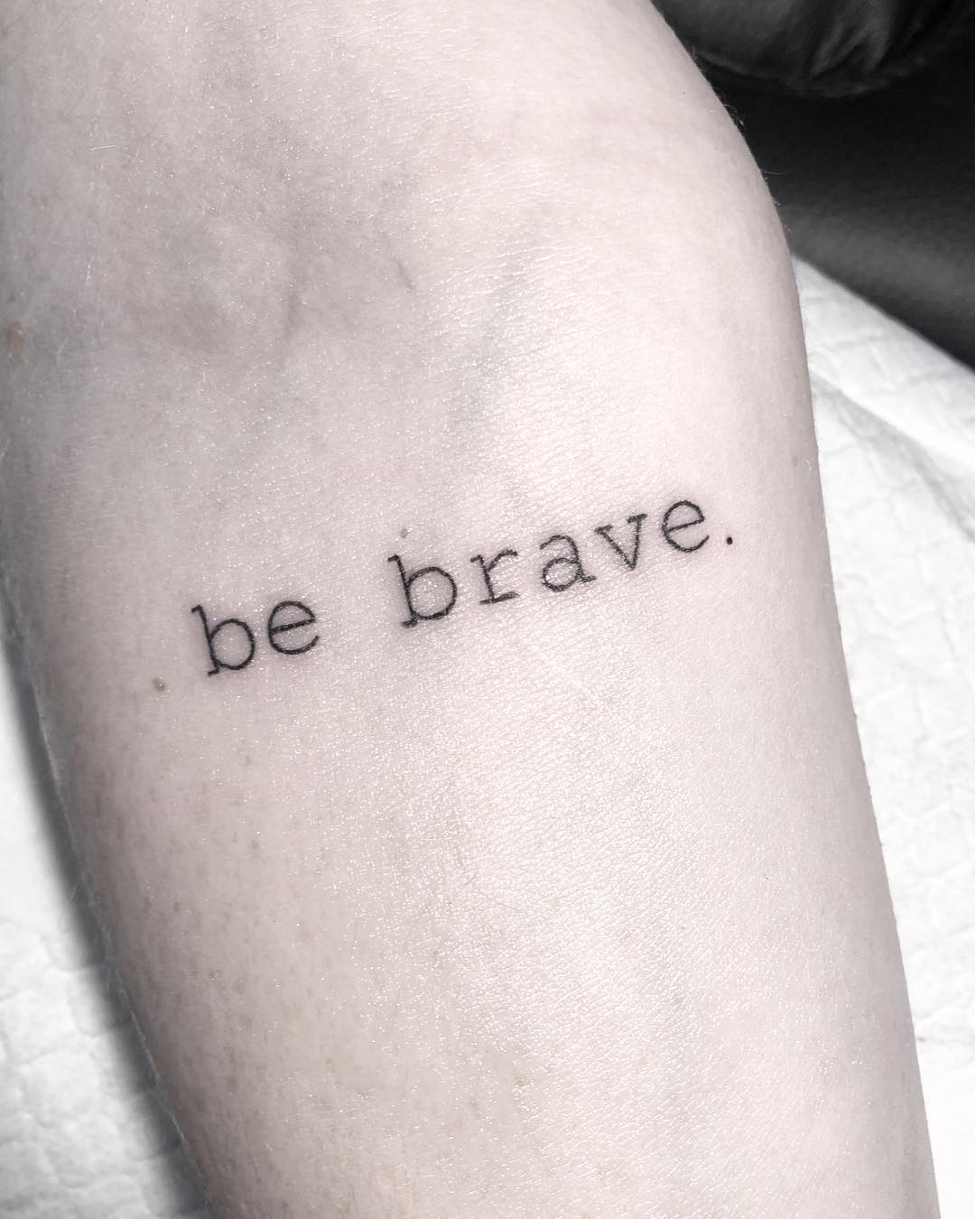 Minimalist tattoo promoting courage and strength