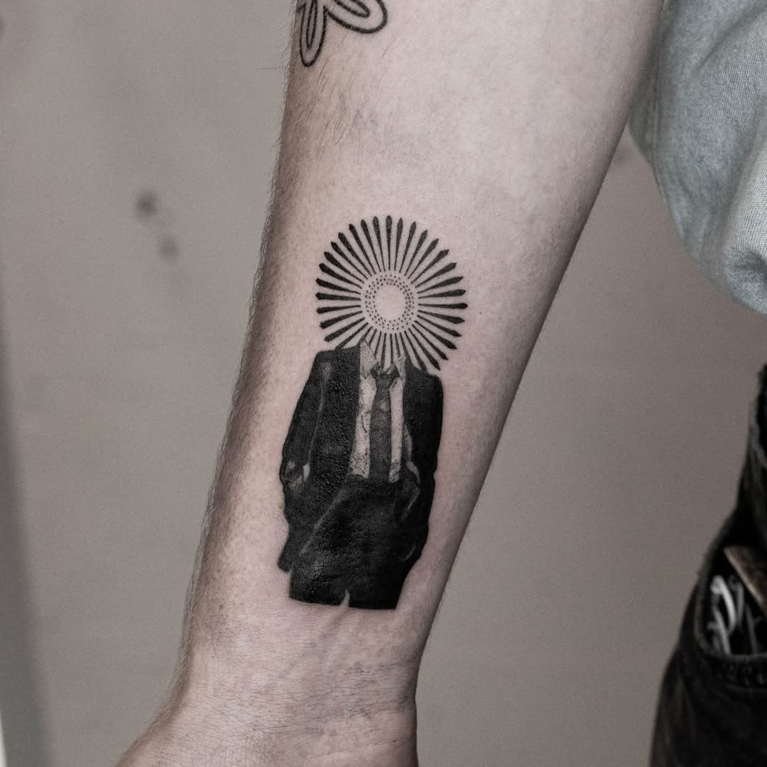 Unique tattoo blending suit and sunburst design