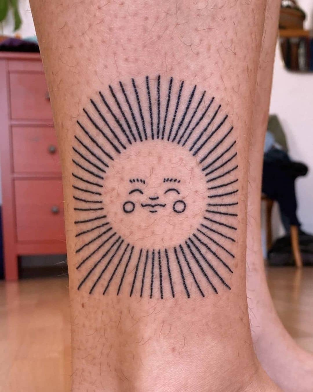 A bright and cheerful sun tattoo design