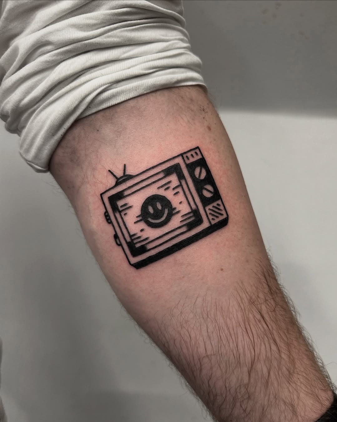 Whimsical TV Tattoo with a Smiley Face