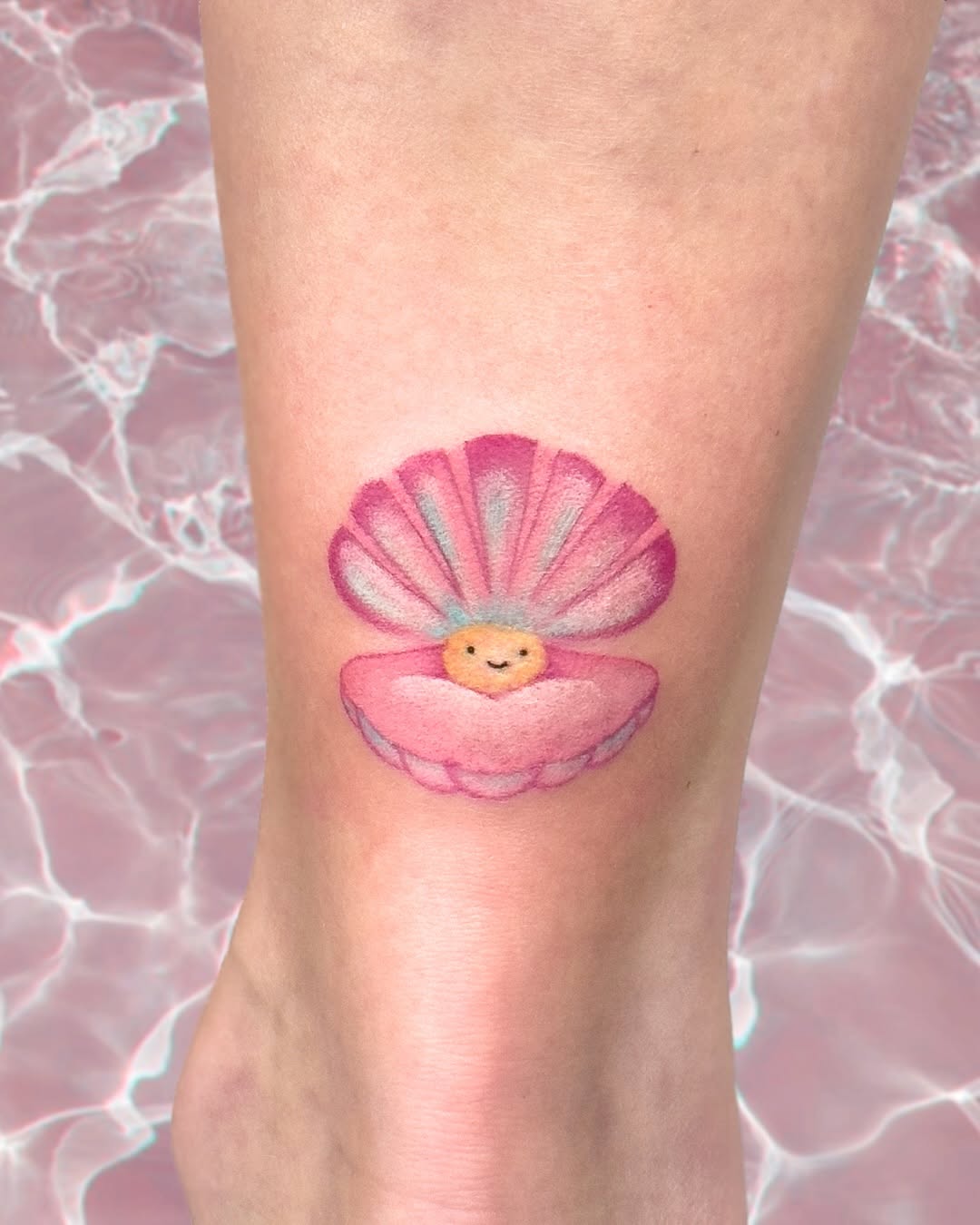 Adorable clam shell tattoo exuding cheerful vibes