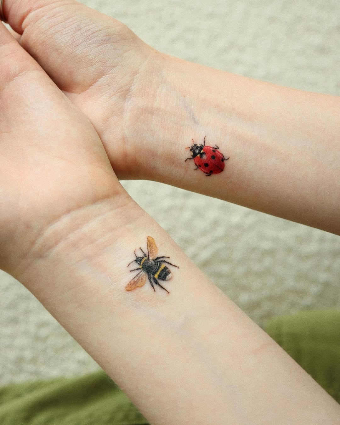 Delicate bee and ladybug tattoos for bonds