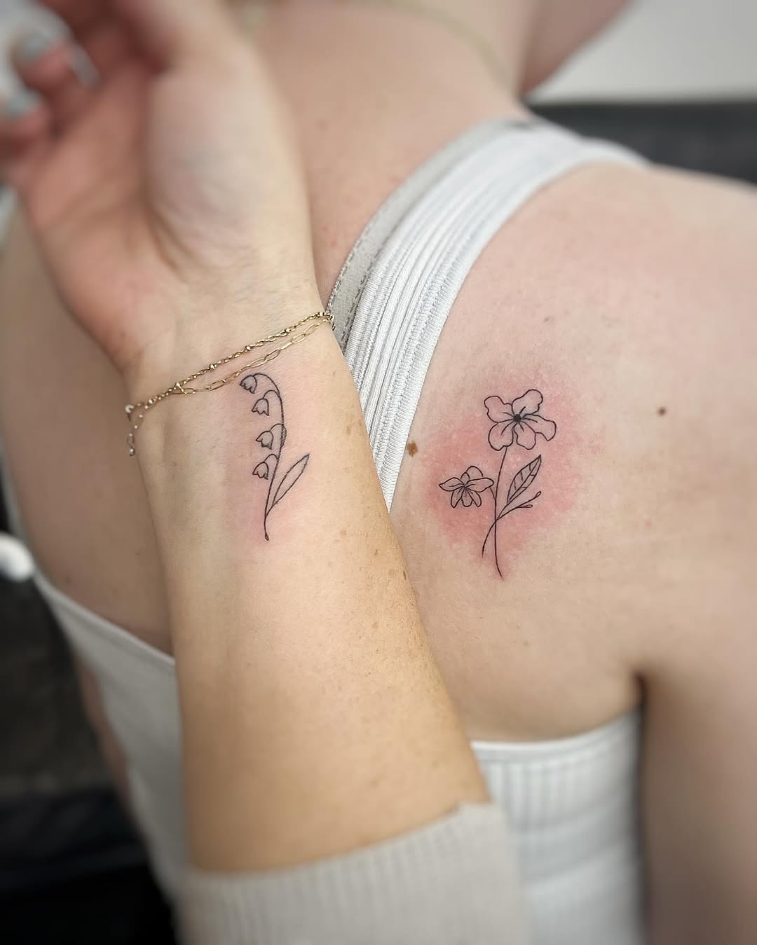 Delicate floral tattoos symbolizing mother-daughter bond
