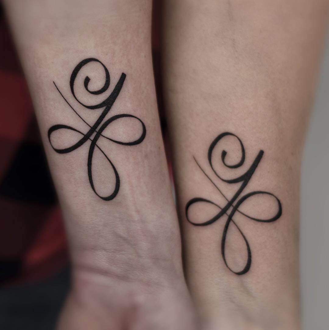 Elegant matching mother-daughter tattoo design