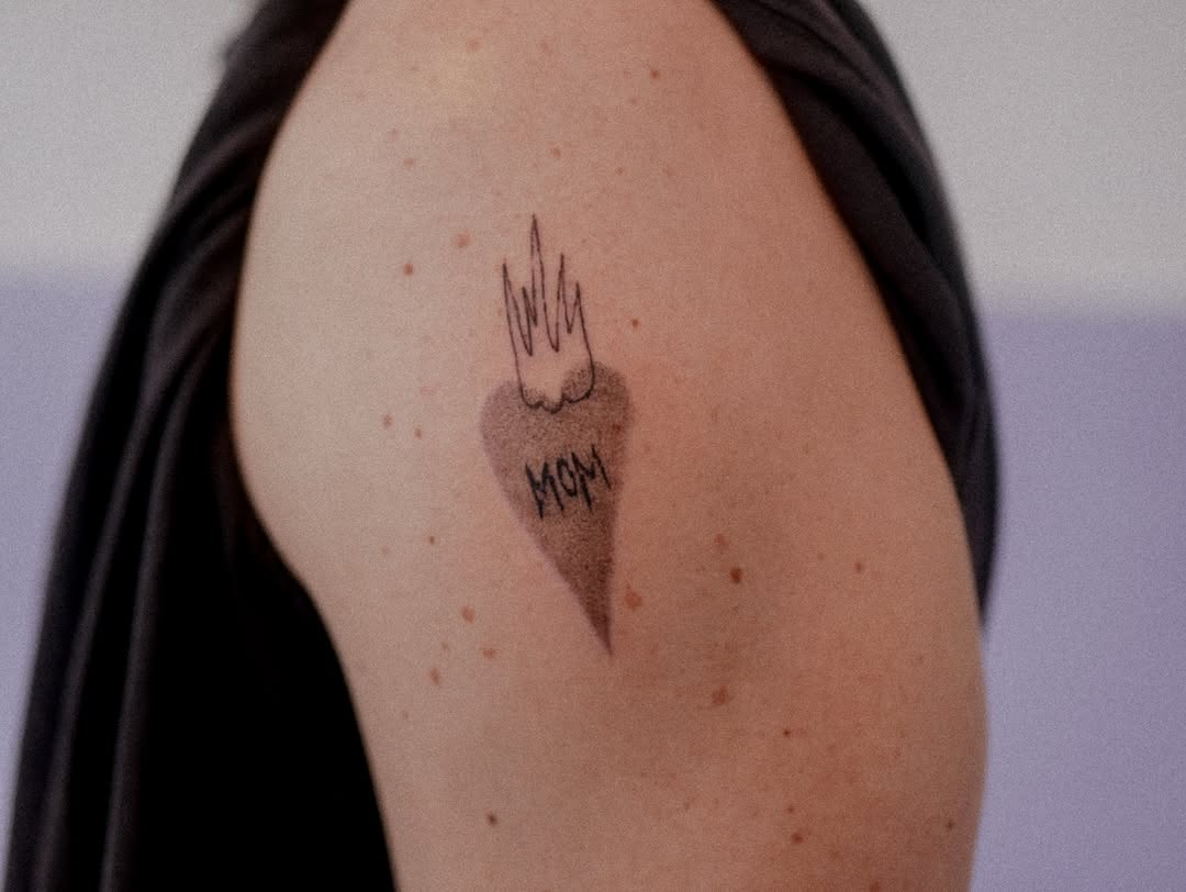 Flame-inspired heart tattoo honoring mothers