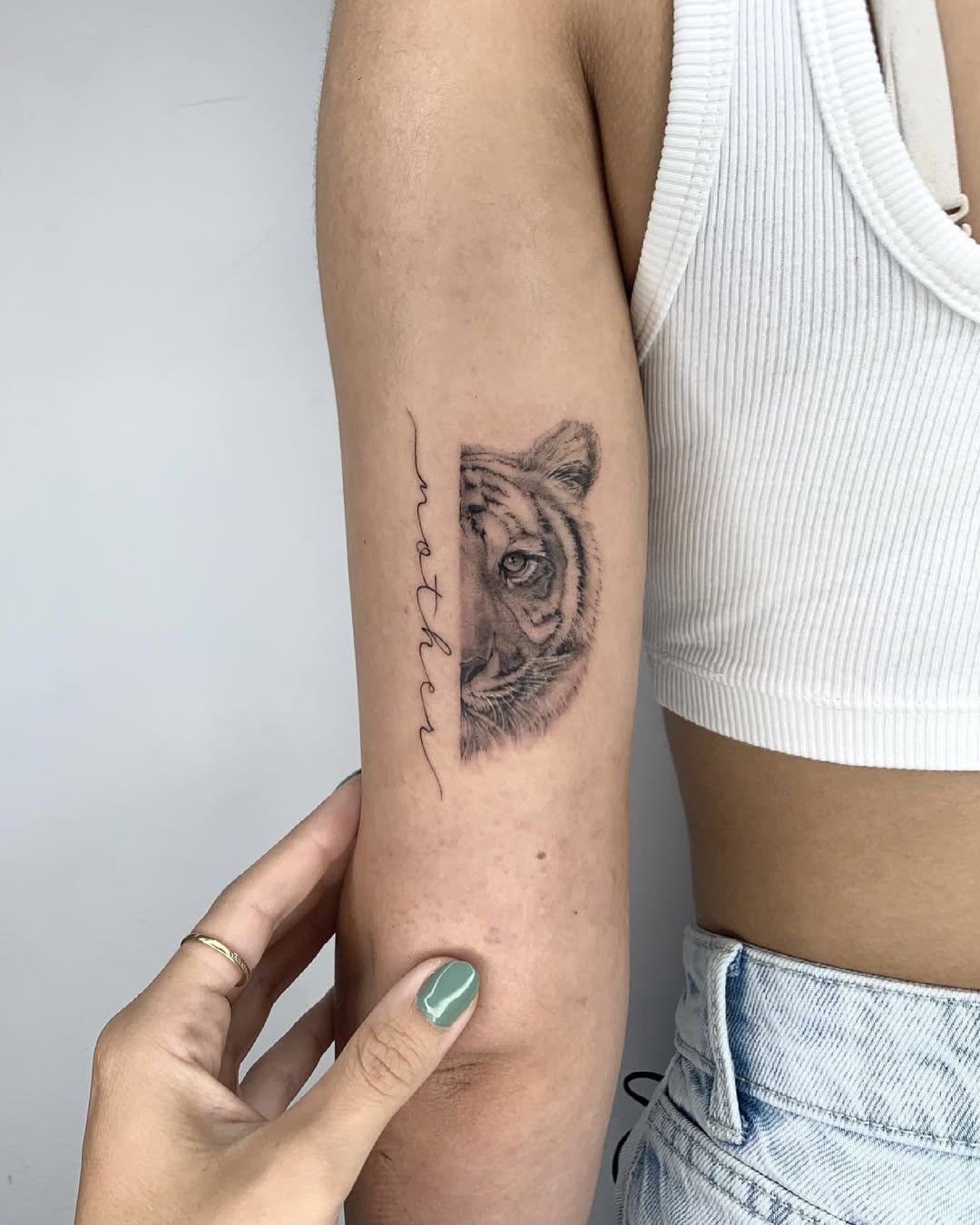 Stunning tattoo of a tiger with 'mother' script