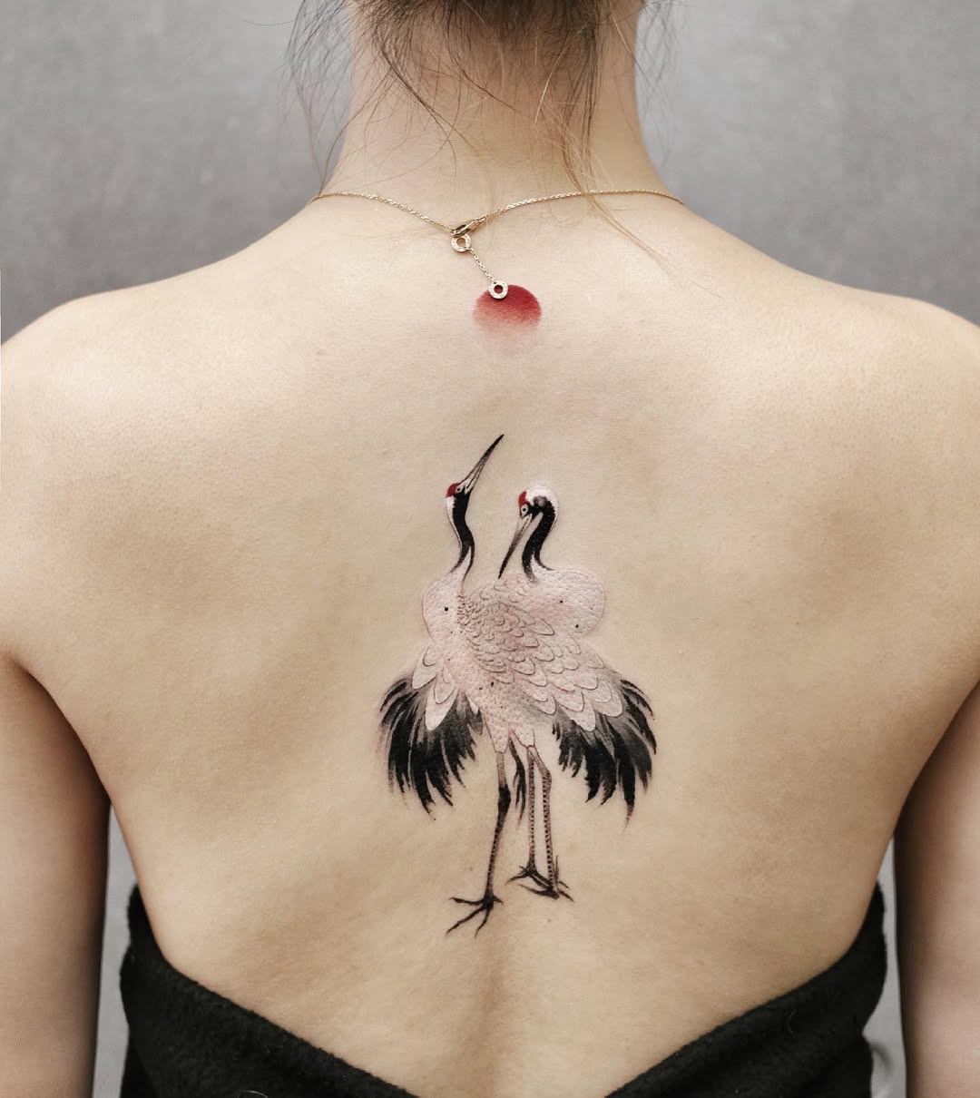 Elegant cranes adorned on the spine region