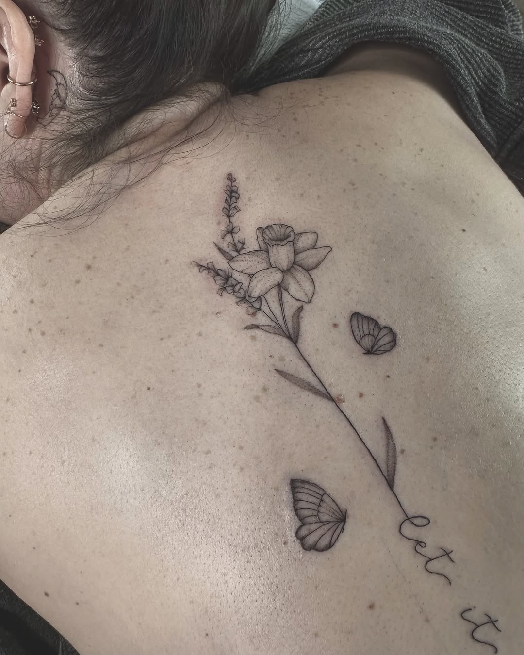 Elegant floral spine tattoo with butterflies