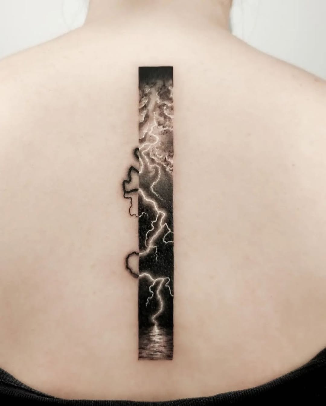 Striking Lightning Tattoo Along the Spine