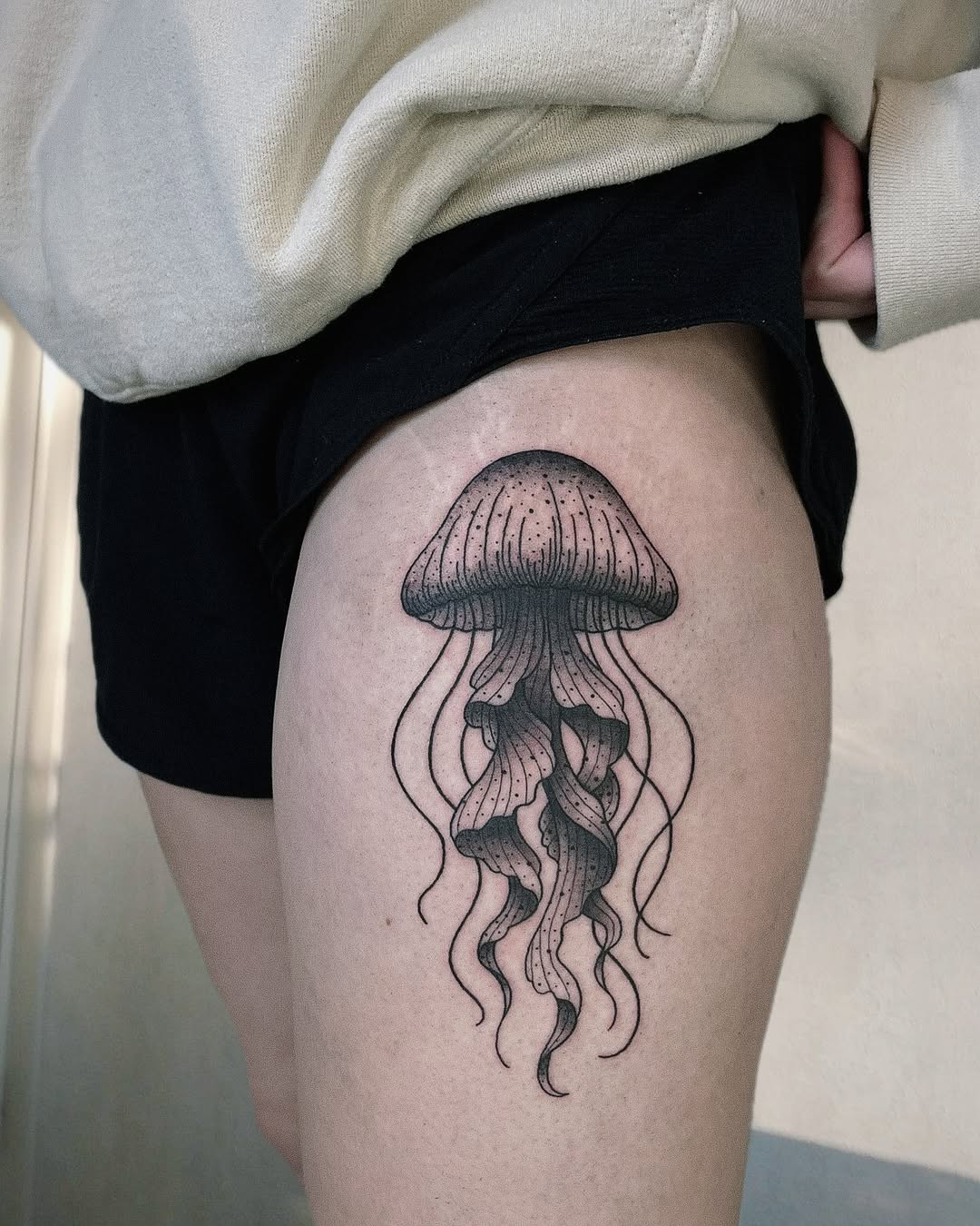 Charming jellyfish tattoo on a thigh