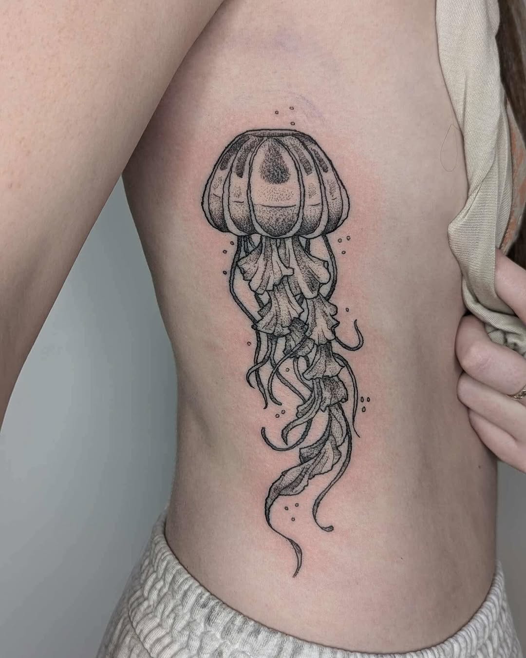 Stunning jellyfish tattoo on rib cage