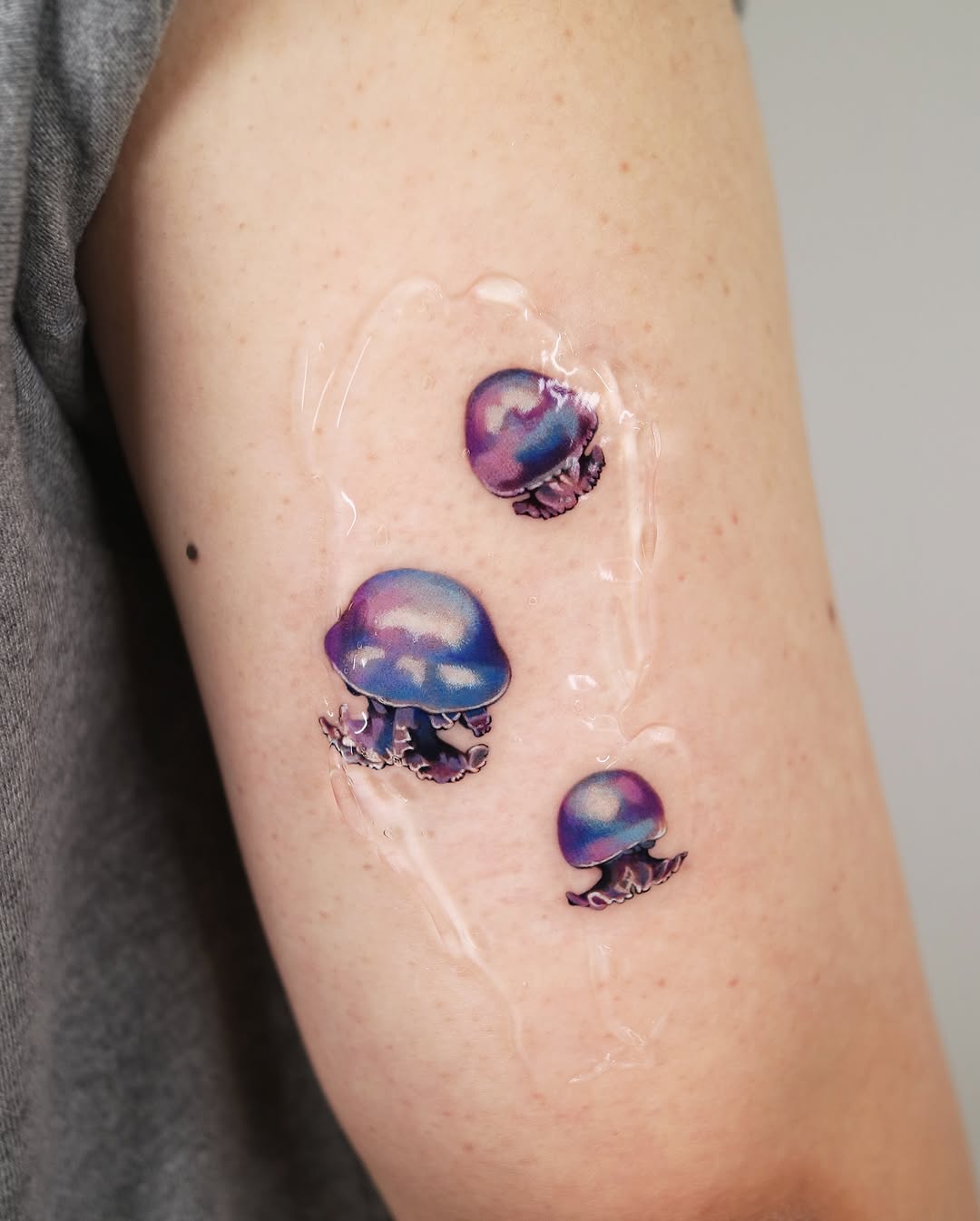 Vibrant jellyfish tattoos with a watercolor style