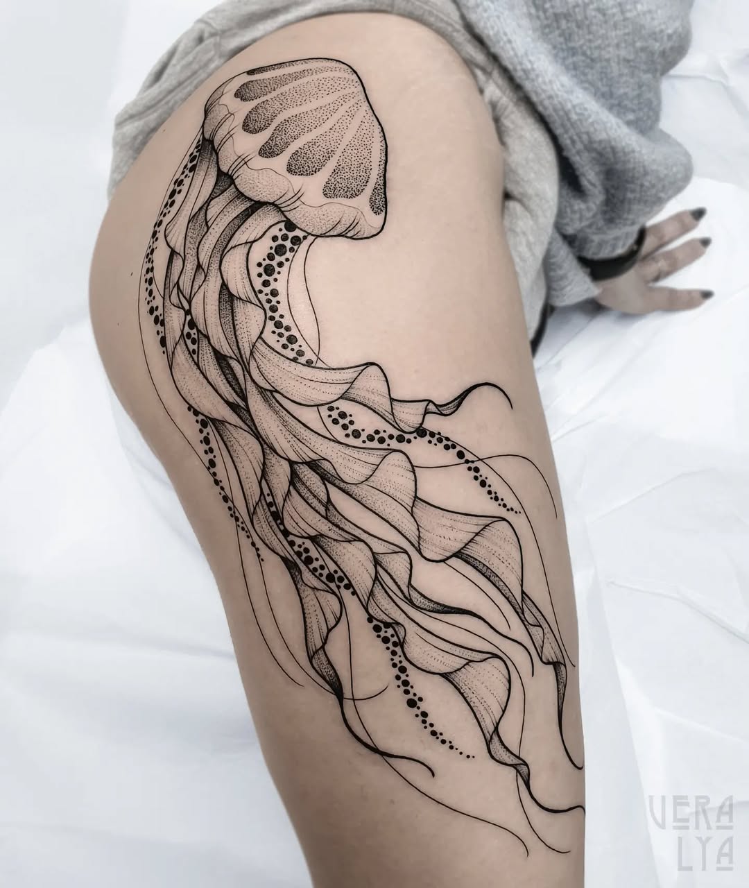 Elegant jellyfish tattoo featuring intricate line work