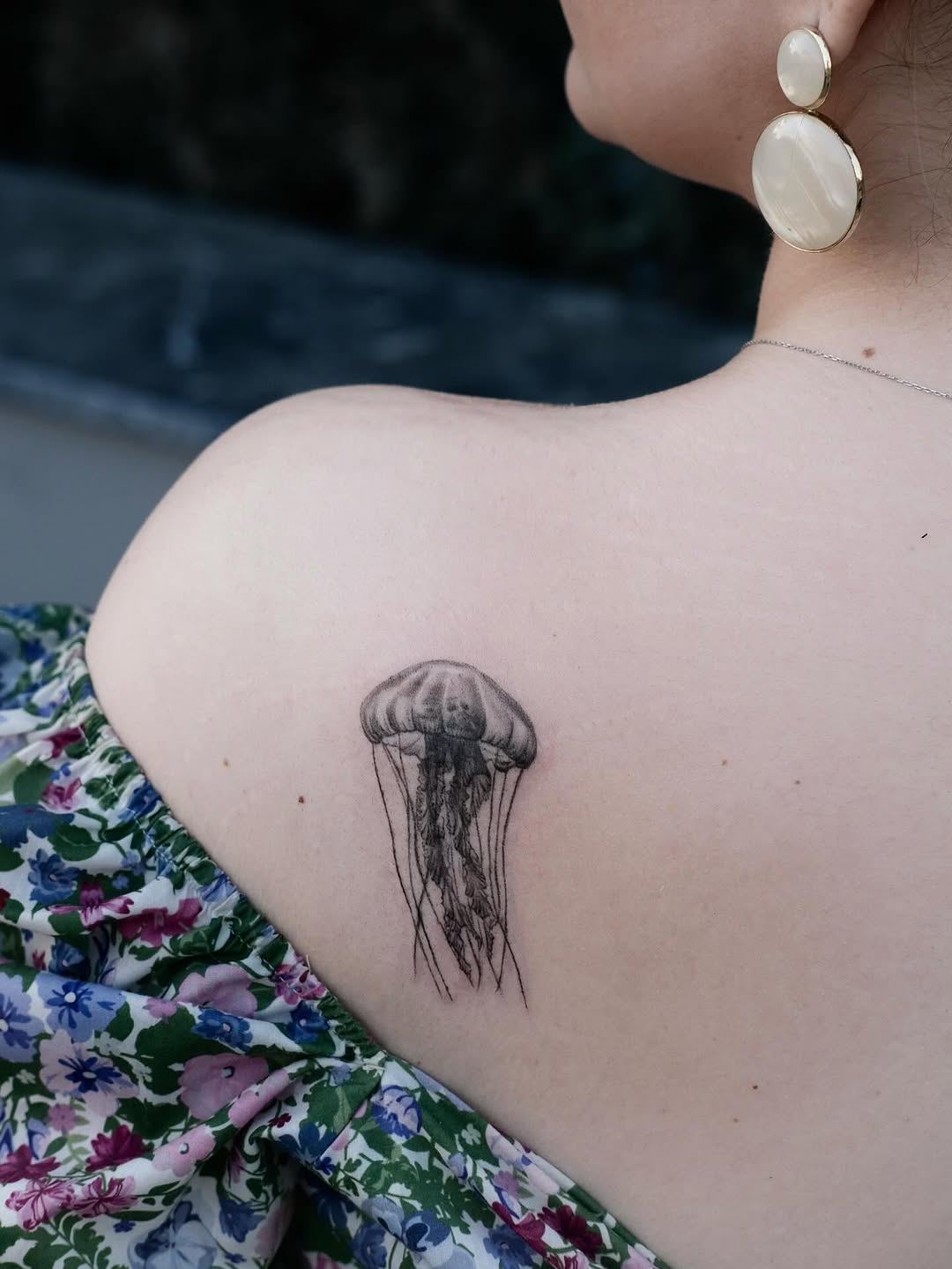 Elegant jellyfish tattoo on shoulder decor.
