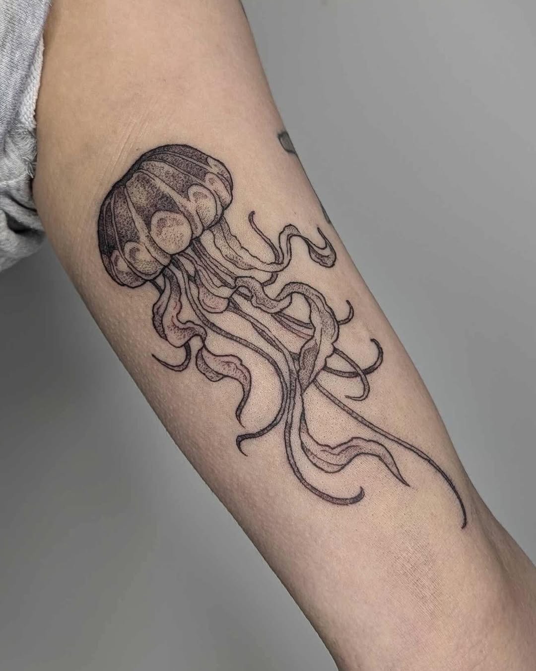 Elegant jellyfish tattoo with delicate linework