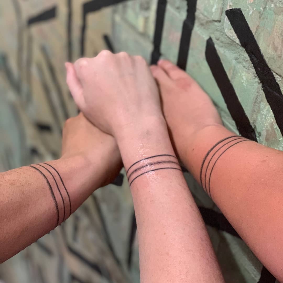 Minimalist sibling tattoos with clean lines