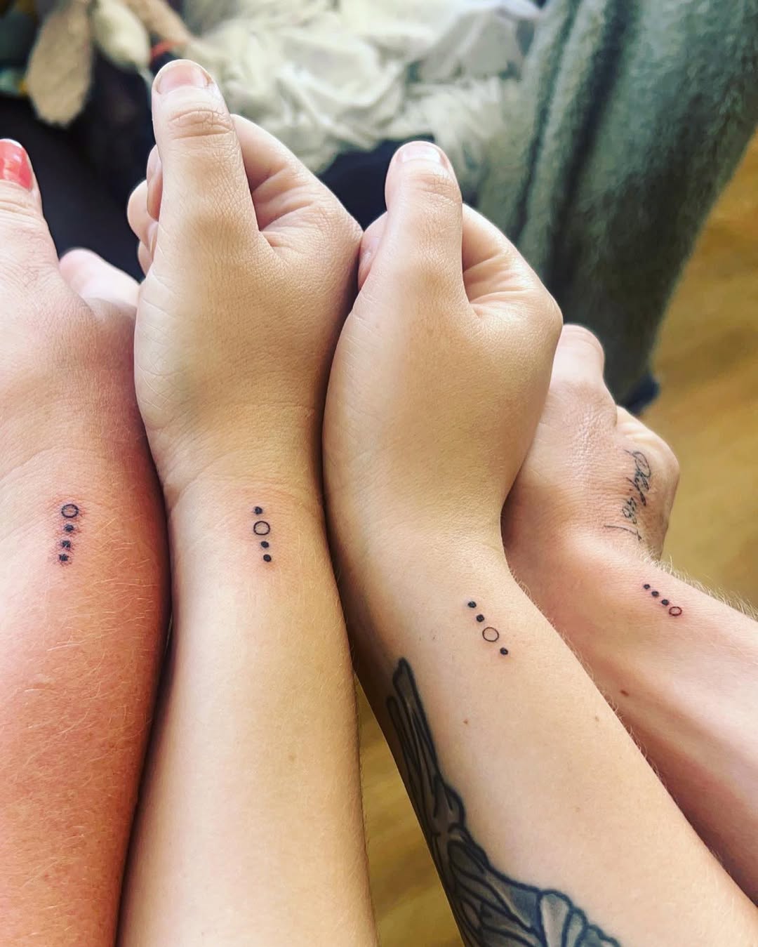 Minimalist sibling tattoos in a stylish line
