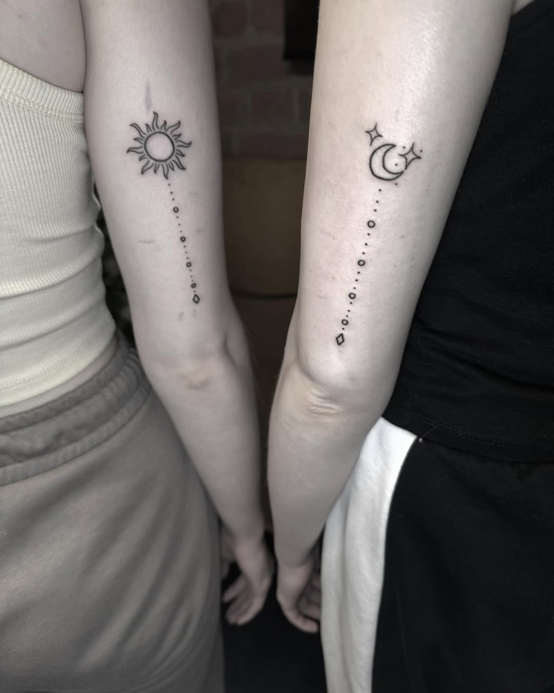 Sun and moon sibling tattoos with a cosmic touch