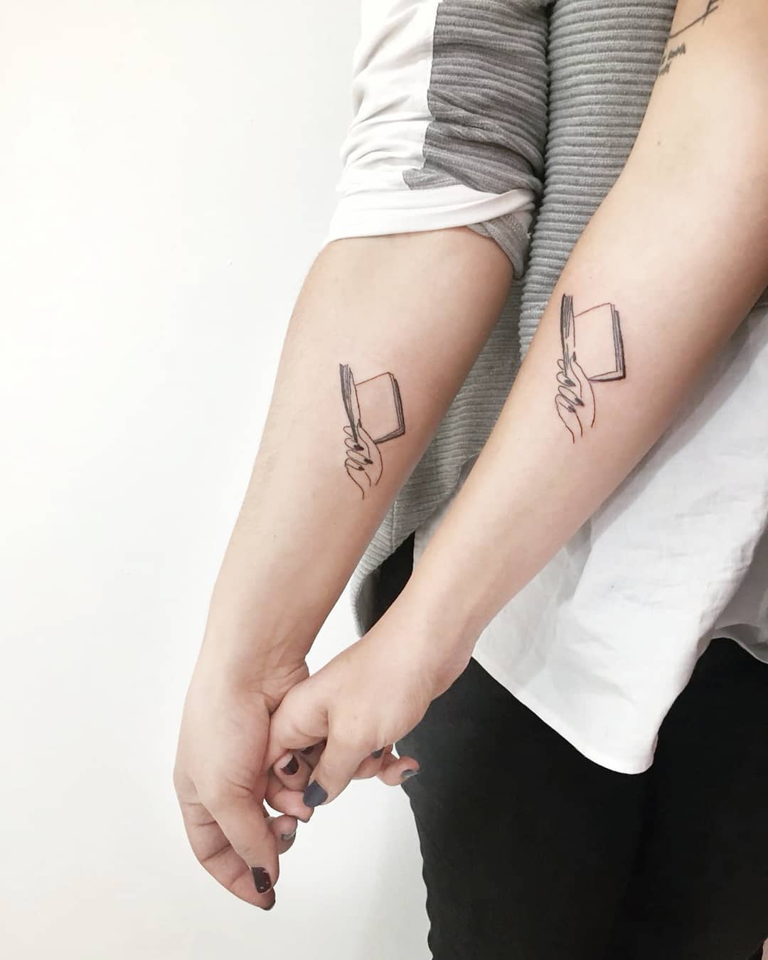 Stylish sibling tattoos depicting connection and love