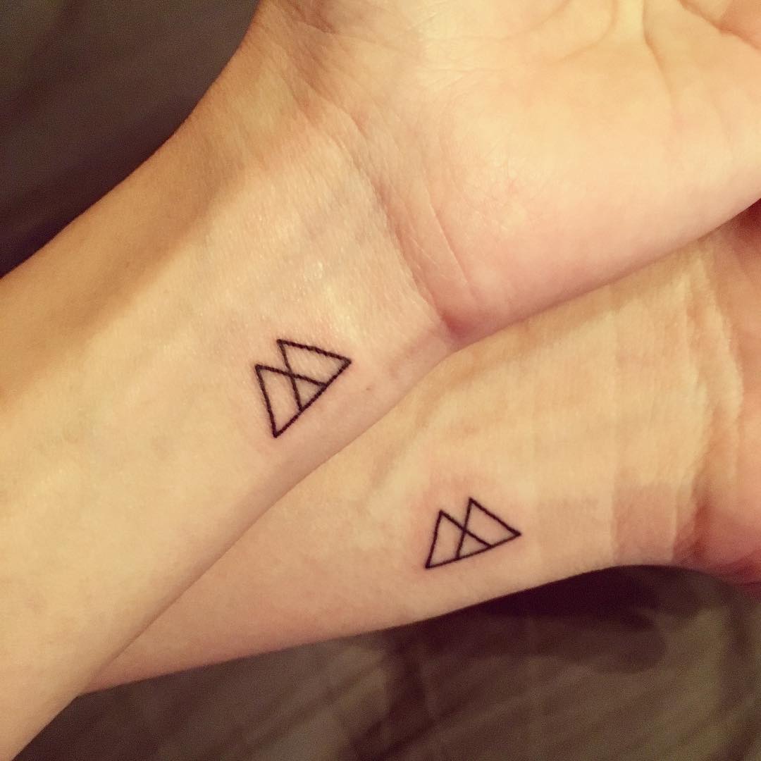 Minimalist sibling tattoos with geometric designs