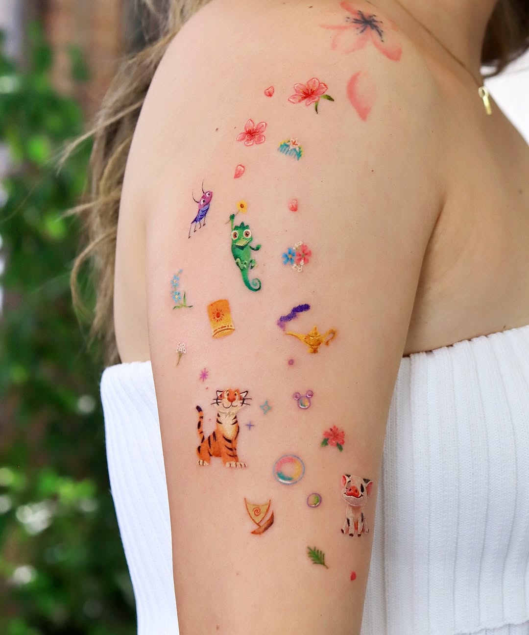 Playful Disney tattoos on an arm